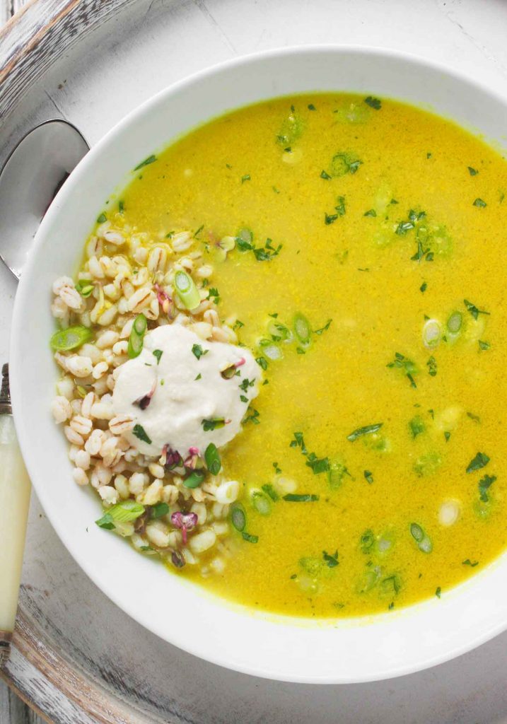 A white bowl filled with Lemongrass Curry Soup.