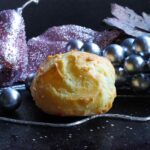 A puffy, cheesy gougere with Christmas decorations.