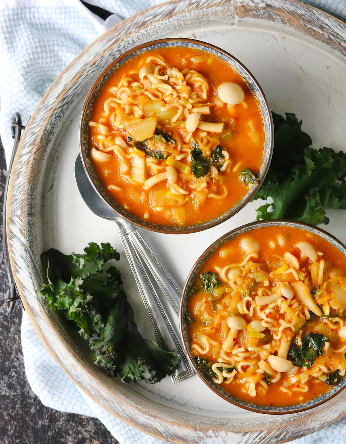 Overhead shot of two bowls of kimchi ramen noodle soup