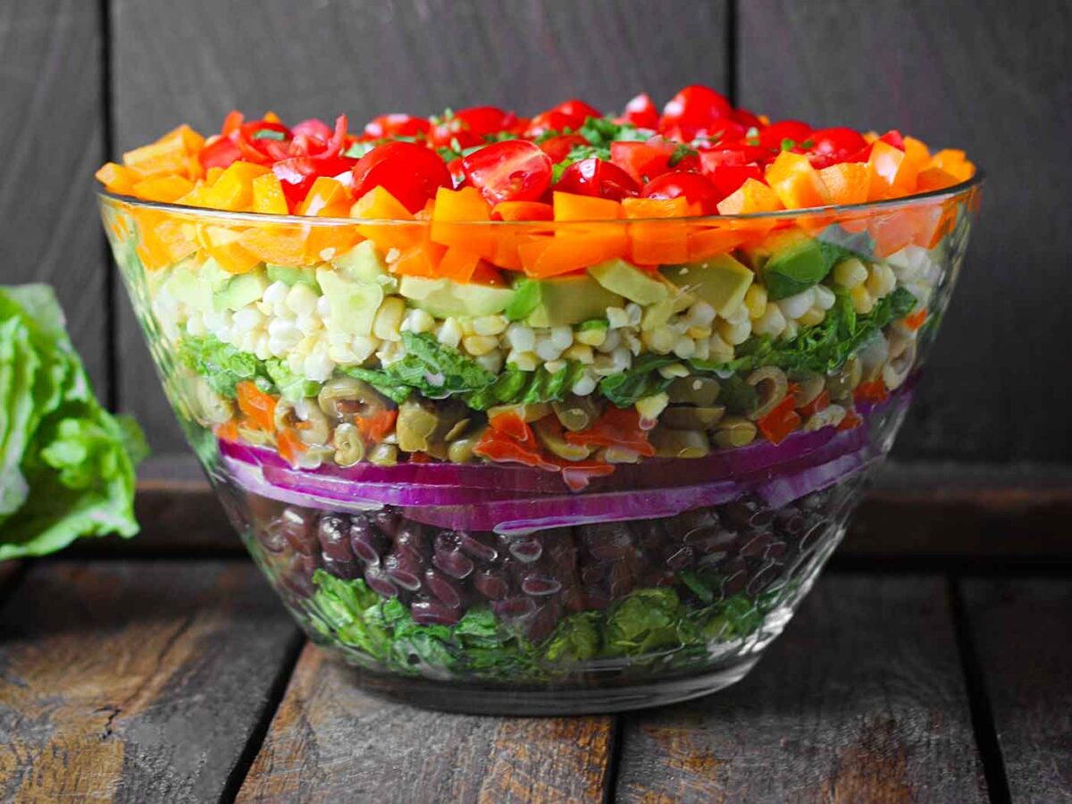 Side view of Seven Layer Salad in a glass bowl.